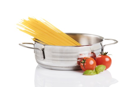 Raw pasta in metallic pot isolated on white background.の写真素材
