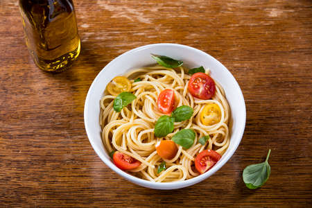 Delicious paste and olive oil bottle on wooden backgroundの写真素材