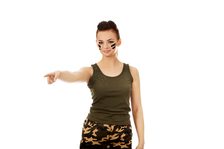 Young soldier woman pointing for something.の写真素材