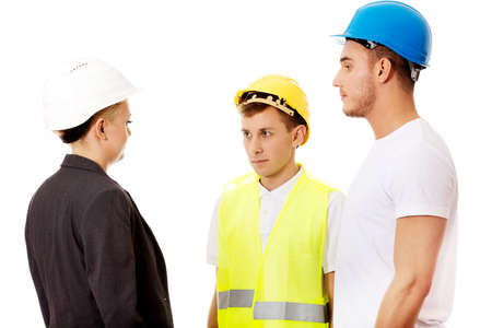 Female engineer talking with two builders.の写真素材