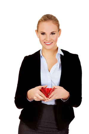 Young happy business woman holding red wallet.の写真素材