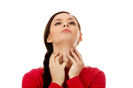Young woman is scratching her neck.の写真素材