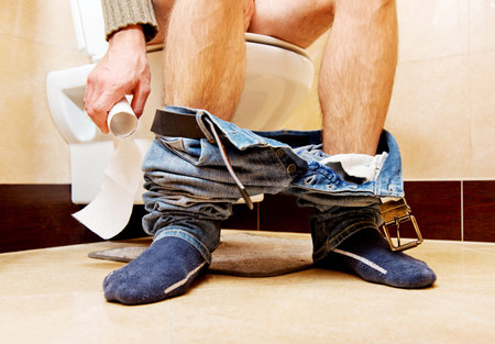 Man sitting on a toilet seat.