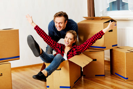 Happy couple having fun in new home.