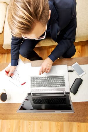 Man working on laptop at home.の写真素材