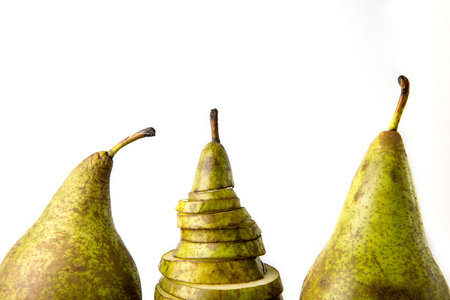 Three pears: one cutting and two whole on white bakground.