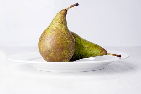 Two pears on white plate.の写真素材