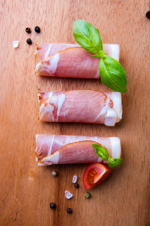 Black forest ham on wooden cutting board.の写真素材