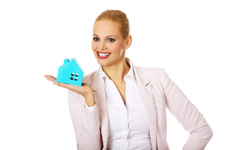 Smile business woman holding a paper house.の写真素材