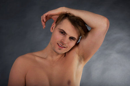 Young shirtless muscular man smiling to camera.の写真素材