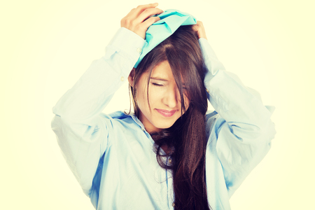 Young morning woman in big shirt with headache.の写真素材