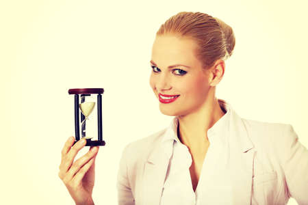 Young business woman holding hourglass.Time concept.の写真素材