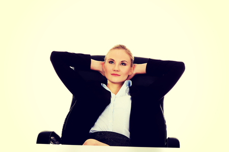 Happy business woman relaxing in office.の写真素材