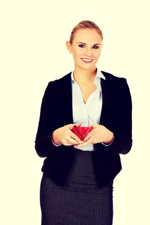 Young happy business woman holding red wallet.の写真素材