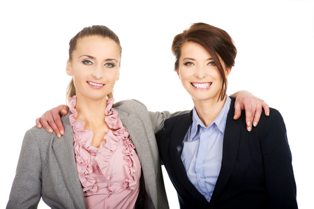 Beautiful two businesswomen embracing each other.の写真素材