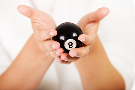 Businesswoman holding eight billiard ball.
