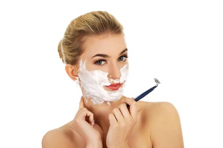 Young woman have morning shave, isolated on whiteの写真素材