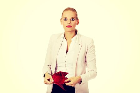 Worried business woman shows her empty wallet.の写真素材