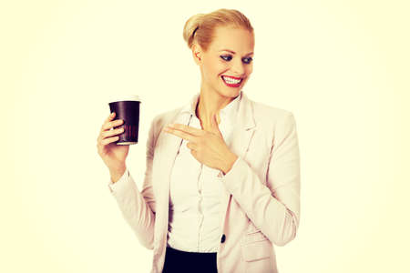 Smile business woman pointing for paper cup.の写真素材