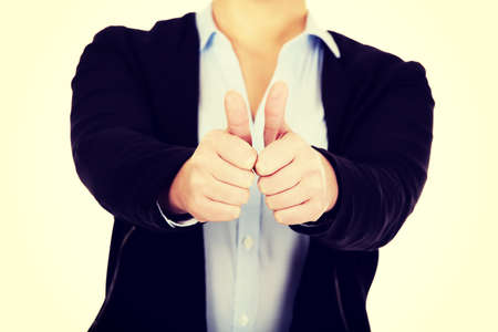 Young business woman shows thumbs up.の写真素材