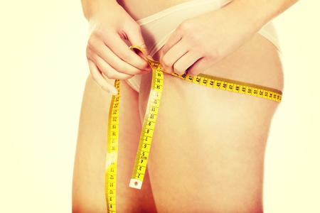 Female buttocks with a measurement tape.の写真素材