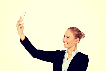Happy business woman taking selfie photo smartphone.の写真素材