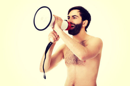 Handsome shirtless man shouting using a megaphone.の写真素材