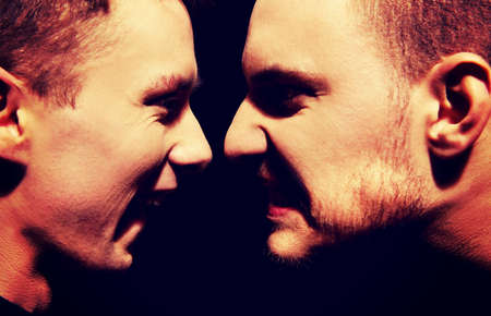 Side view on two screaming men.の写真素材