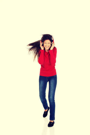 Young woman with headphones listening music.の写真素材