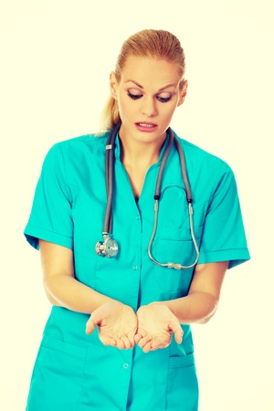 Female doctor or nurse holding something on open palms.の写真素材