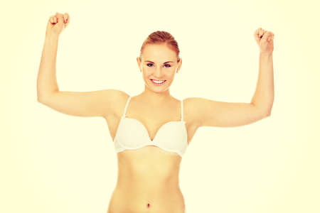 Athletic woman in white underwear shows her muscles.の写真素材