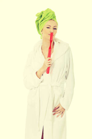 Beautiful caucasian woman with oversized toothbrush.の写真素材