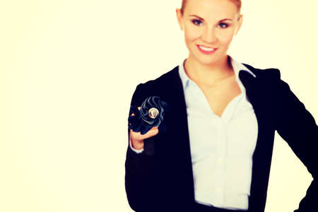 Business woman pointing on camera with umbrella.の写真素材
