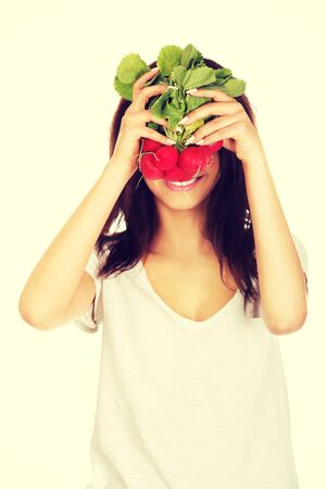 Young african woman cover with bunch of radishes.の写真素材