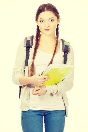 Teenager girl with school backpack holding folder.の写真素材