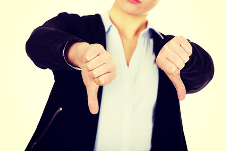 Unhappy businesswoman with thumbs down gesture.