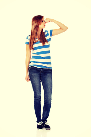Teenage woman holding her nose because of a bad smell.の写真素材