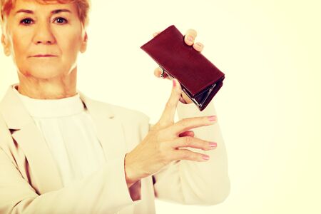 Worried elderly woman with empty wallet.の写真素材