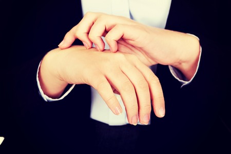 Young elegant woman scratching her hand.の写真素材