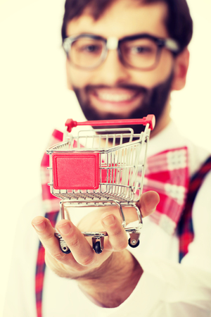 Funny man wearing suspenders with small shopping basket.の写真素材