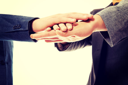 Business team with their hands together.