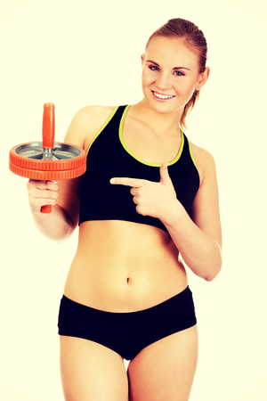 Young and sporty woman holding sport wheel.の写真素材
