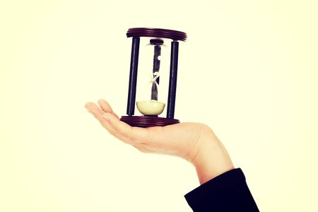 Young business woman holding hourglass-time concept.の写真素材