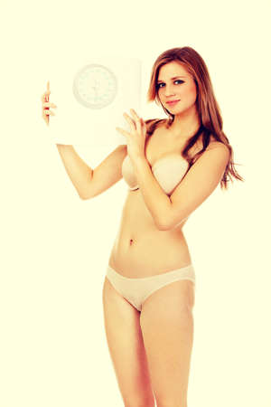 Slim woman holding a scale.の写真素材