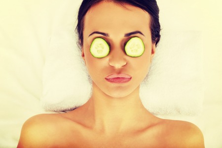 Woman in spa with cucumber on eyes.の写真素材
