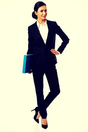 Smiling businesswoman holding a binder.の写真素材