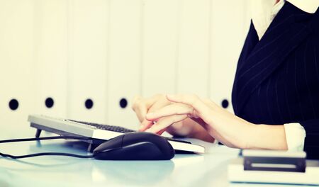A photo of woman's hands working on keyboard.の写真素材