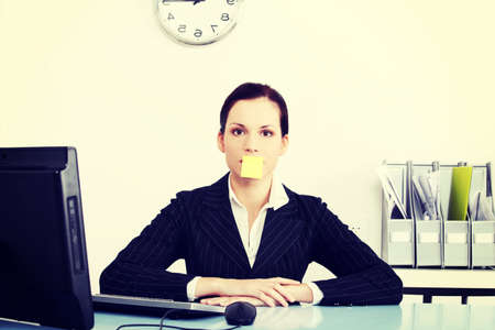 Business woman is having poster card on her mouth.の写真素材