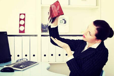 business woman is holding empty wallet, in office.Bankruptcy concept.の写真素材