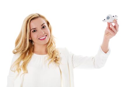 Business woman holding airplane model. Isolated on white.の写真素材